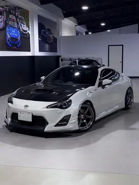 Three quarter perspective profile highlighting the flush fender fitment of an 18 inch Grace Silver RAYS wheel on a white GT86