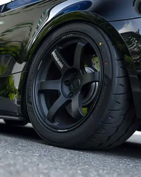 Close up of Matte Black Volk Racing TE37 Saga S-Plus 18 inch wheel showing RAYS logo and M3 performance brakes
