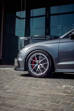 Close up of the split five spoke design on a Diamond Silver BBS RI-A clearing large Audi RS red brake calipers
