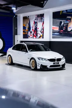 Low angle front view of white BMW F80 M3 showing Gold face Volk 21A wheels in stock at KA Autosport Australia