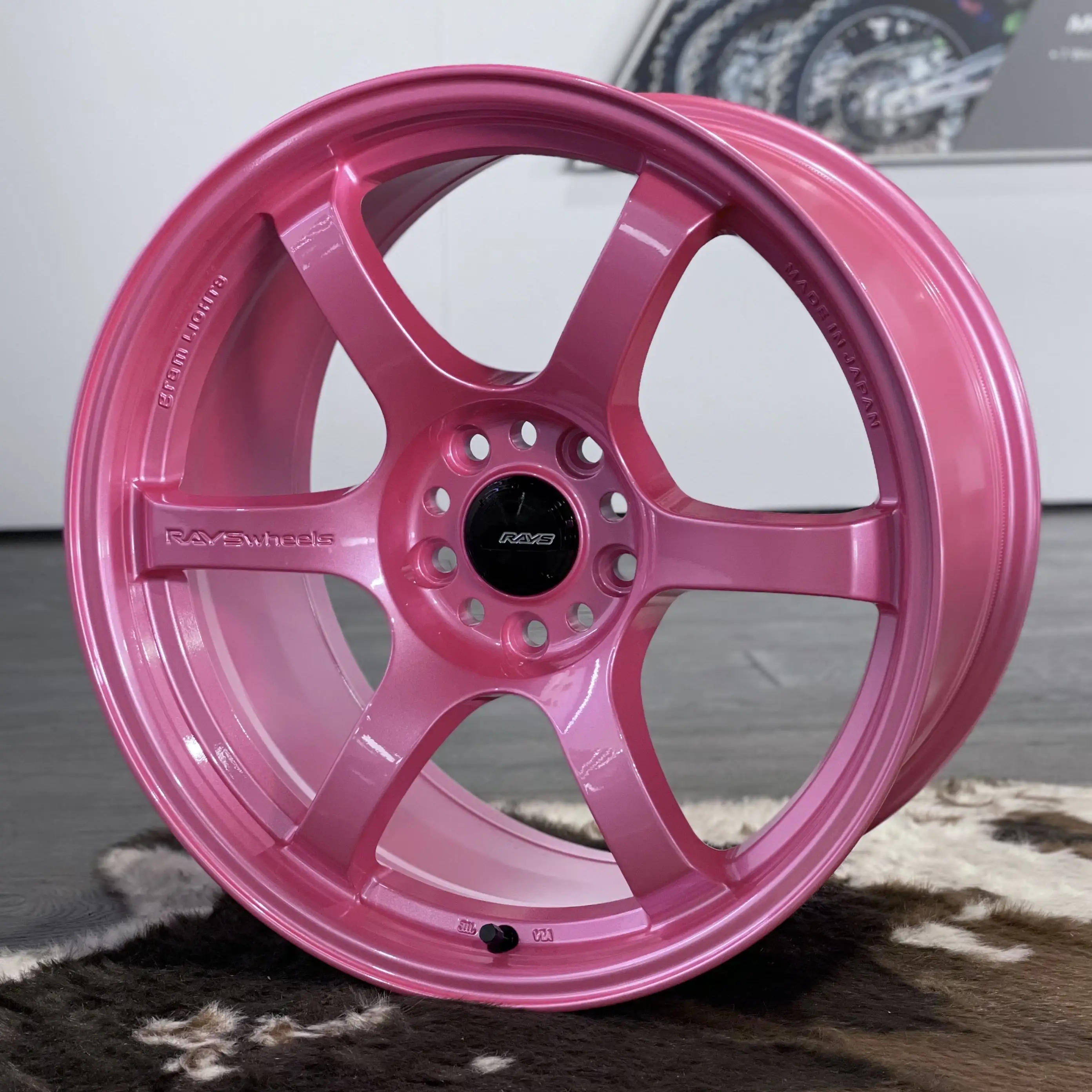 Three quarter studio perspective highlighting the striking six spoke design of a Sakura Pink 57DR wheel