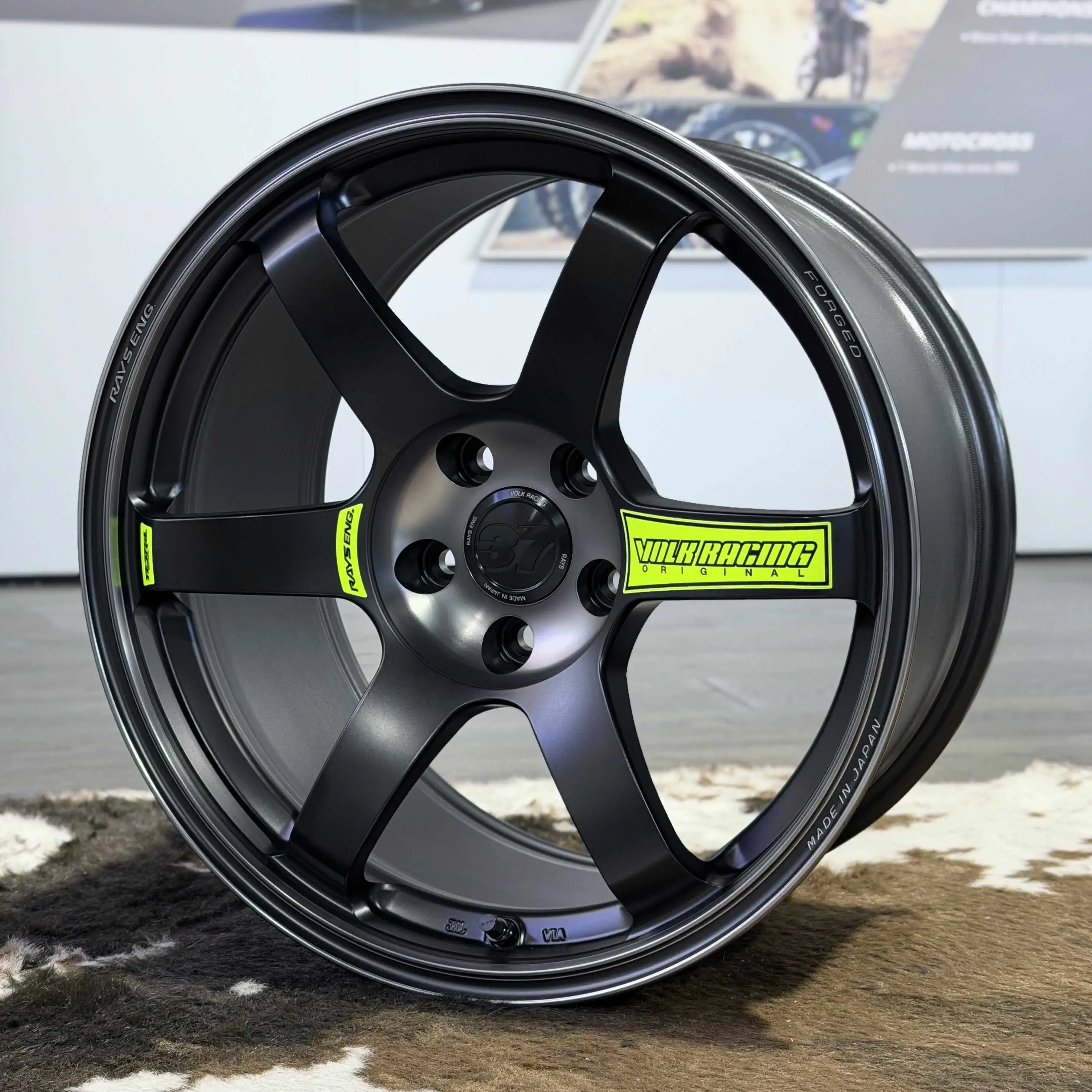 Close-up of vibrant Luminous Green spoke decal on Matte Black RAYS Volk Racing TE37 SAGA SL M-Spec wheel