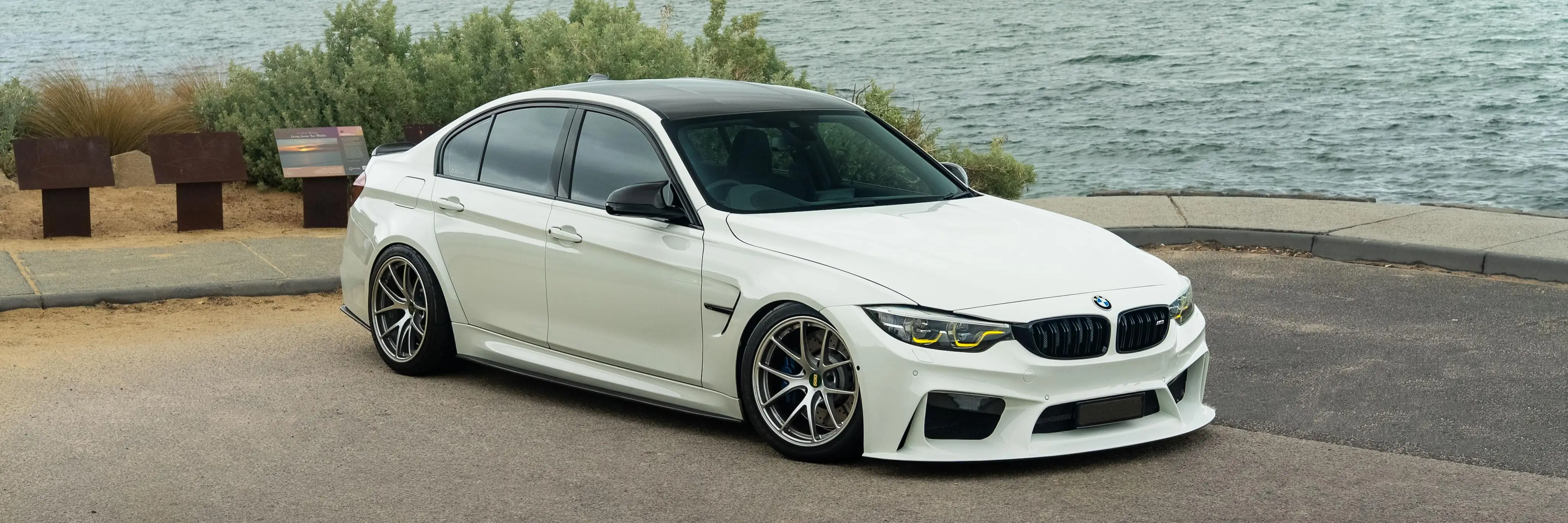White BMW F80 M3 sedan sitting on track spec BBS RI-A forged wheels in Diamond Silver