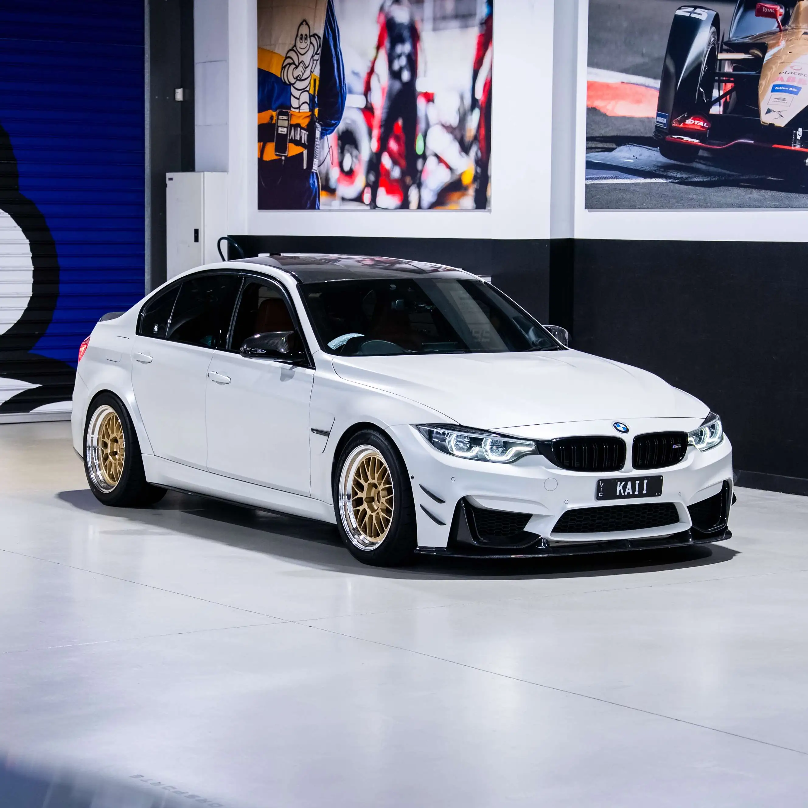 Low angle front view of white BMW F80 M3 showing Gold face Volk 21A wheels in stock at KA Autosport Australia