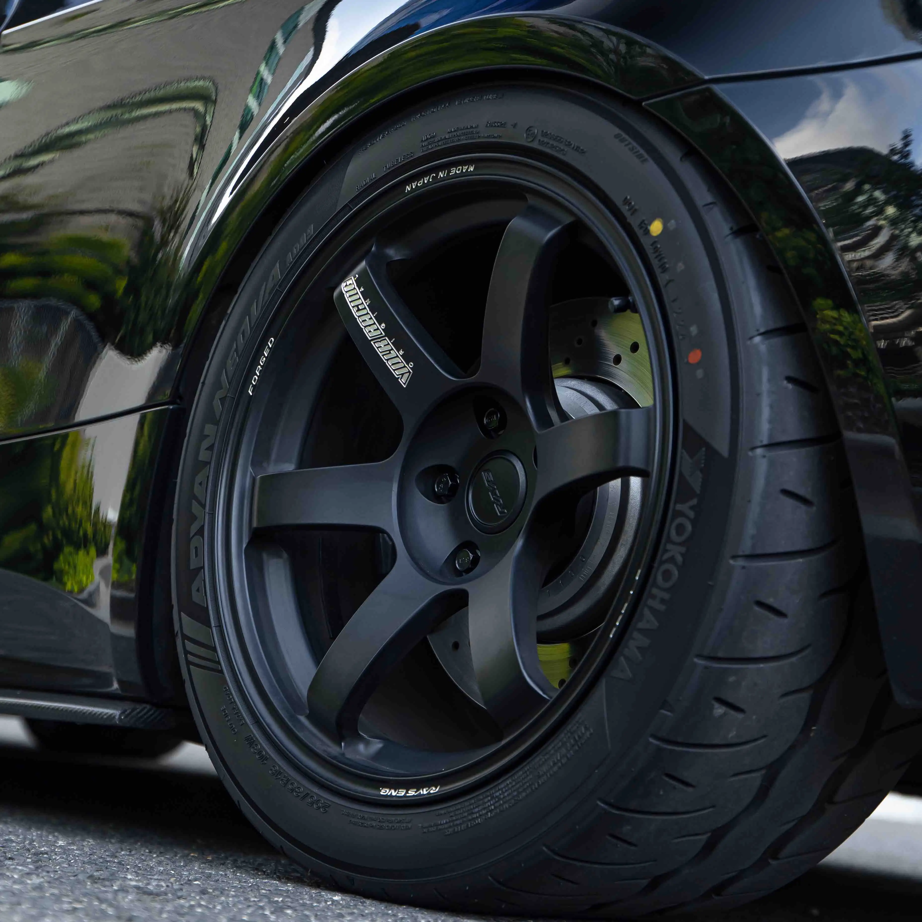 Close up showing aggressive flush wheel fitment of 18 inch TE37 Saga S-Plus in Matte Black on E92 M3 rear quarter