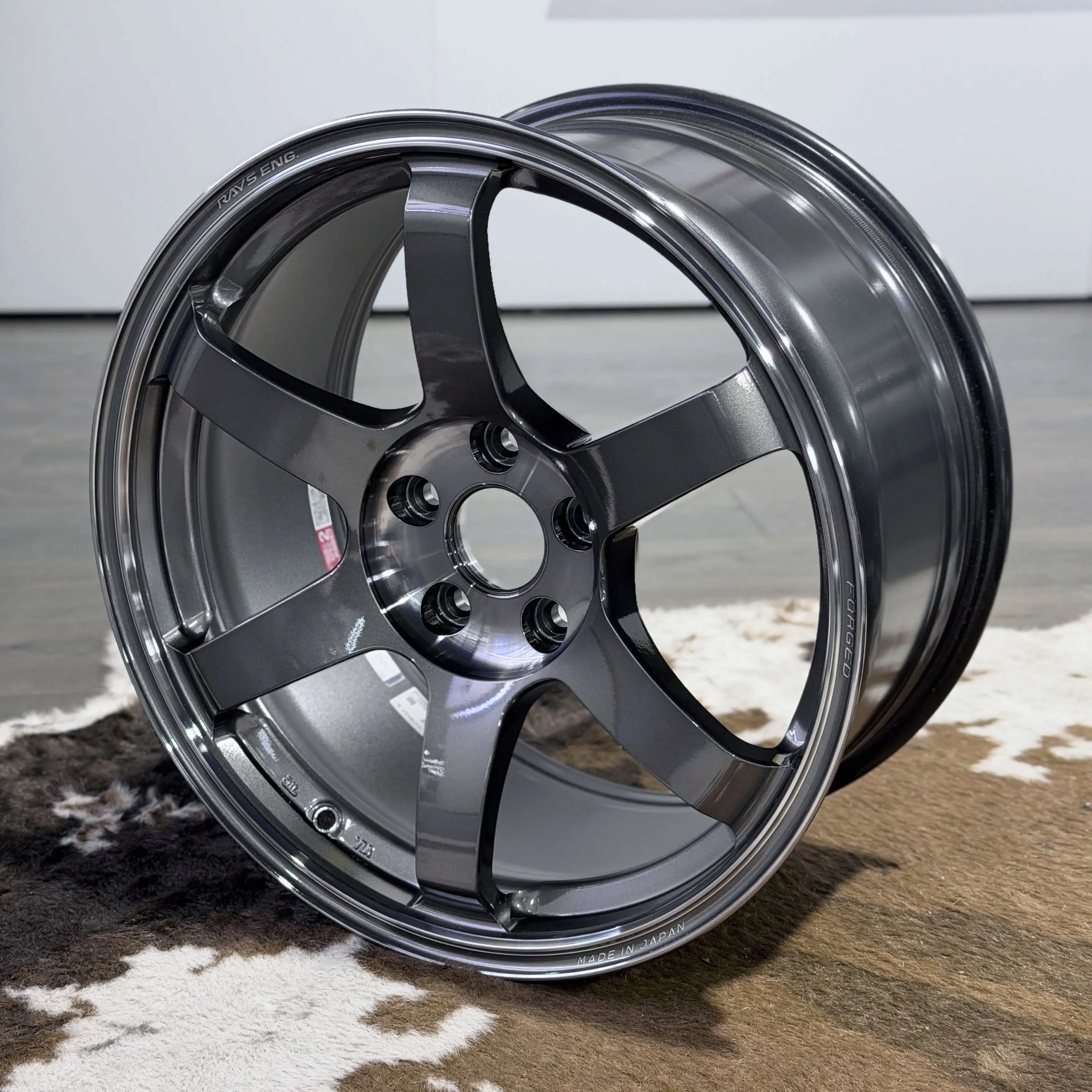 Studio product profile of an 18 inch RAYS Volk Racing TE37 Saga SL wheel in Pressed Graphite finish
