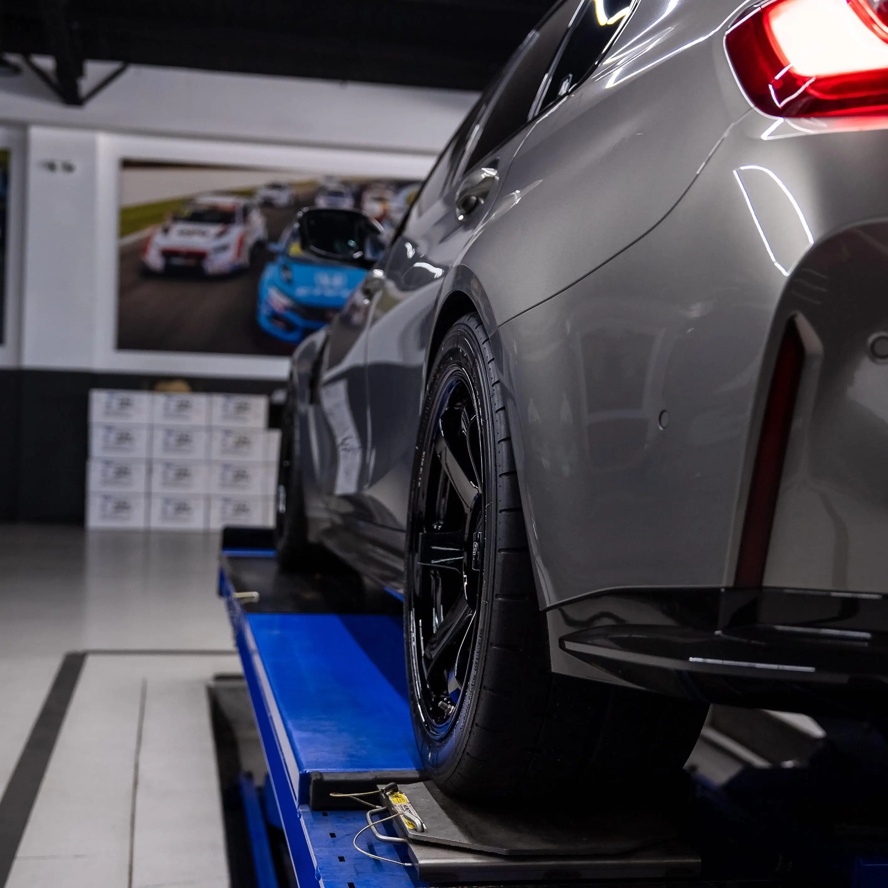 Aggressive rear fitment stance of a BMW G80 M3 running wide gloss black RAYS TE37 wheels