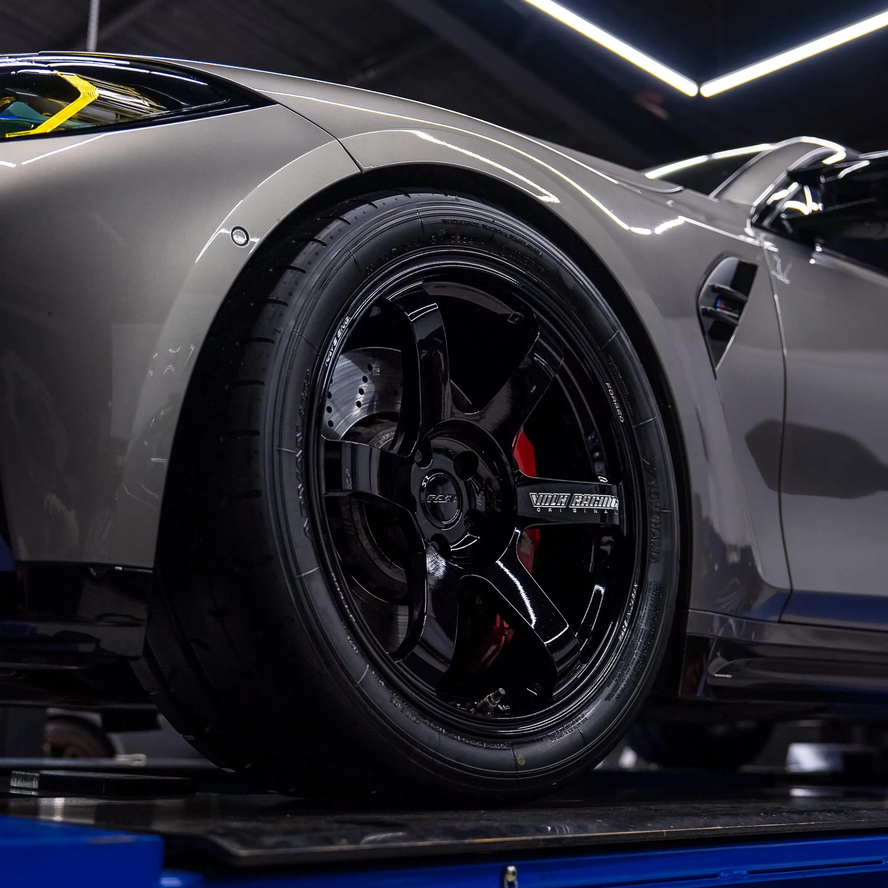Rear three quarter view of a BMW G80 M3 highlighting the deep concave profile of rear TE37 wheels