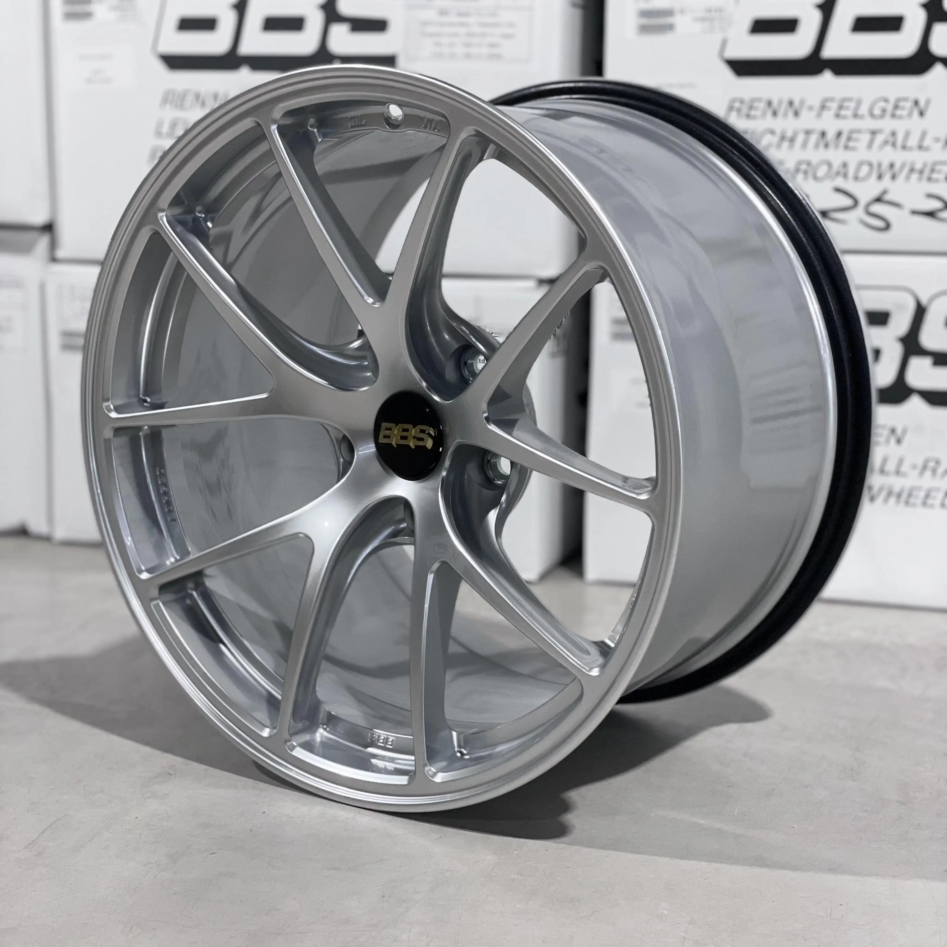 Three quarter studio perspective highlighting the split five spoke design of a Diamond Silver BBS RIA racing wheel