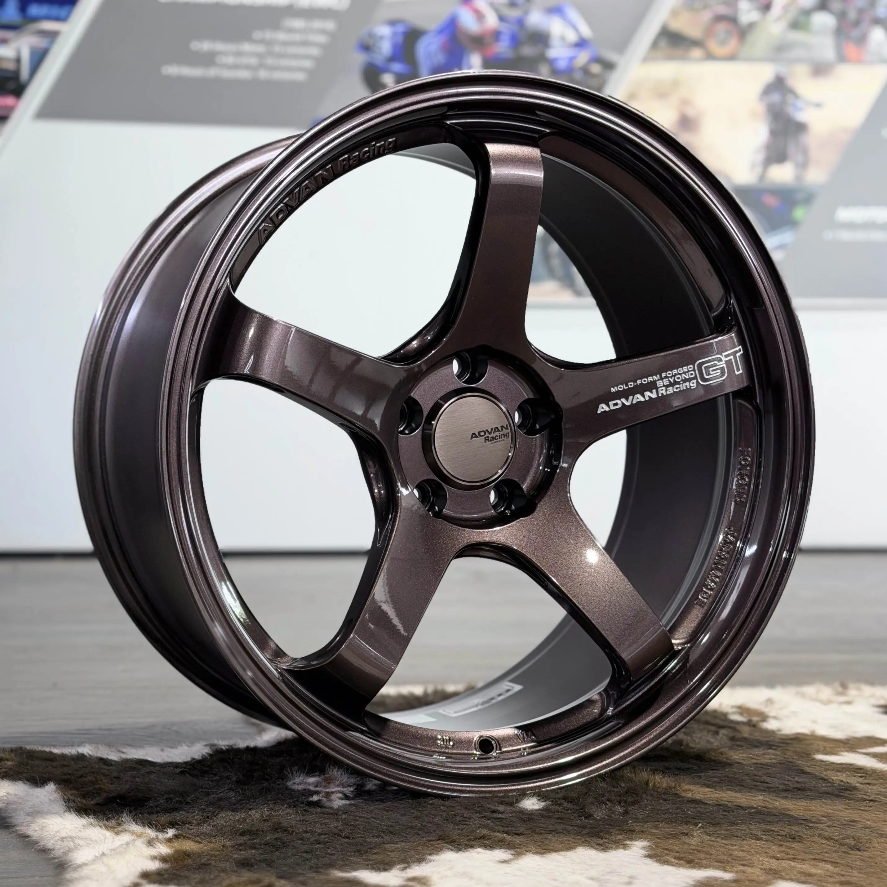 Close up detailing the authentic 3D machined Advan Racing GT Beyond logo lettering on a copper bronze spoke