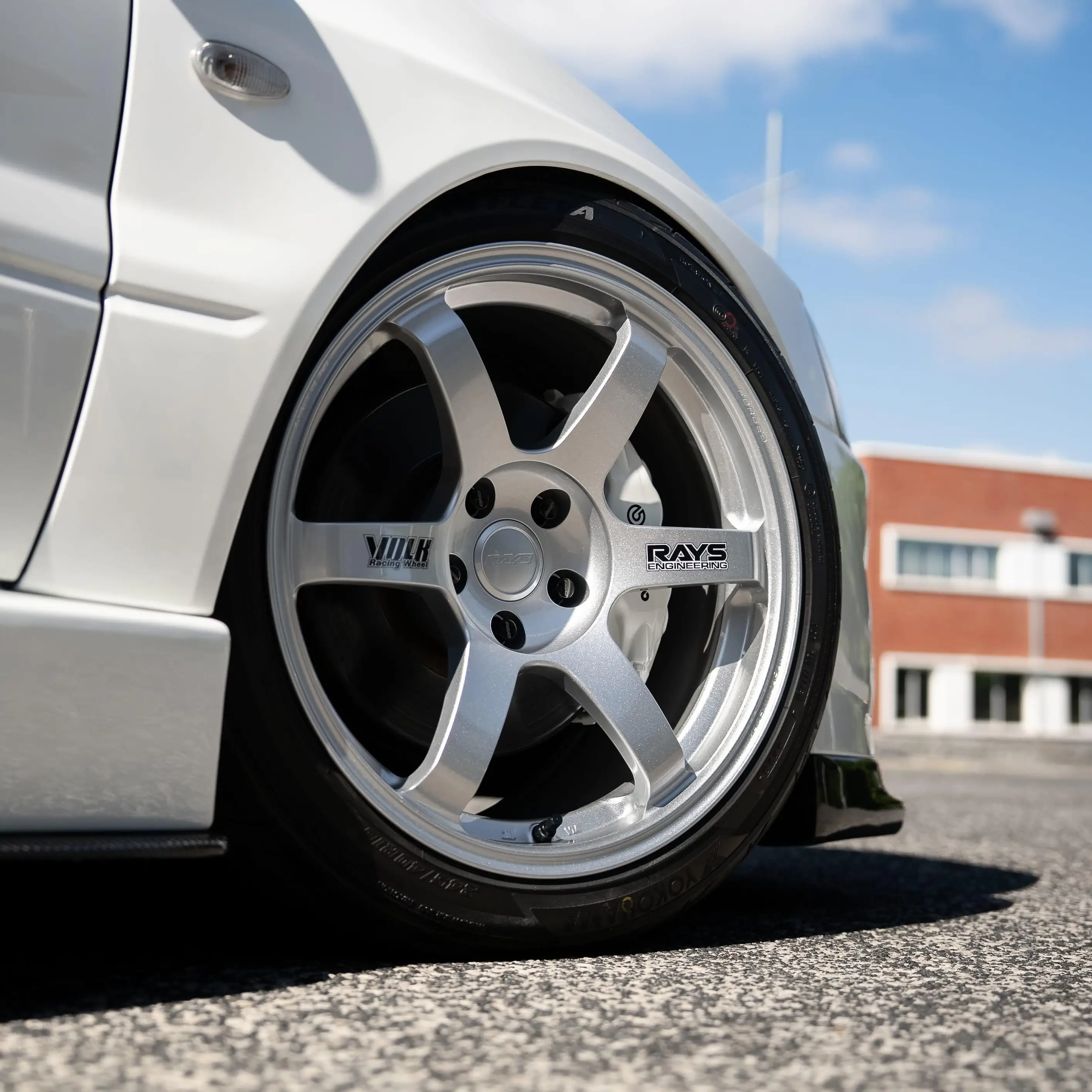 White Mitsubishi Lancer Evolution Evo 8 fitted with RAYS Volk Racing TE37 Saga SL forged wheels in Diamond Silver front close up profile