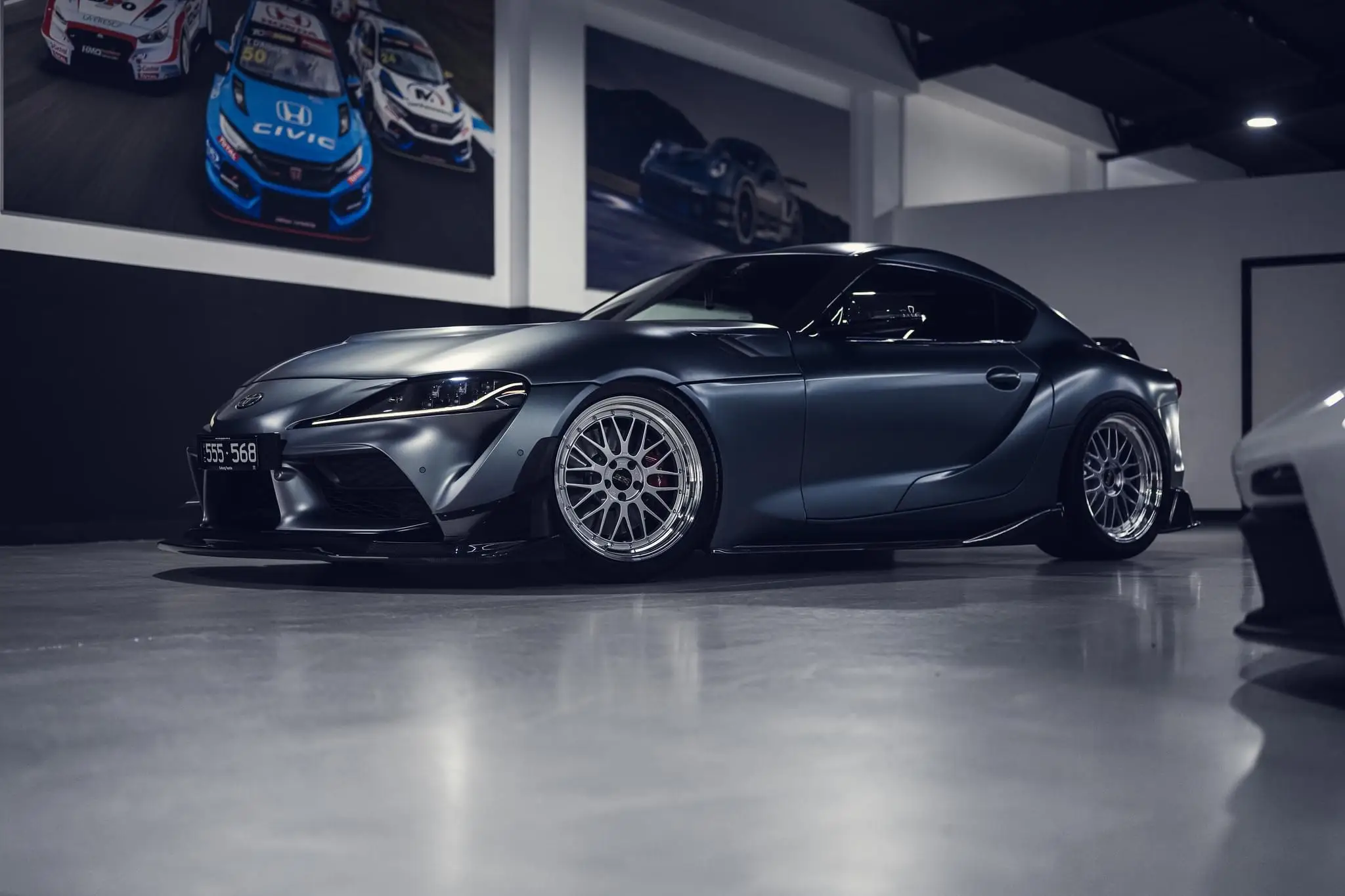 Rear three quarter view of a Toyota GR Supra highlighting deep dish BBS LM rear wheels