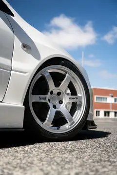 White Mitsubishi Lancer Evolution Evo 8 fitted with RAYS Volk Racing TE37 Saga SL forged wheels in Diamond Silver front close up profile
