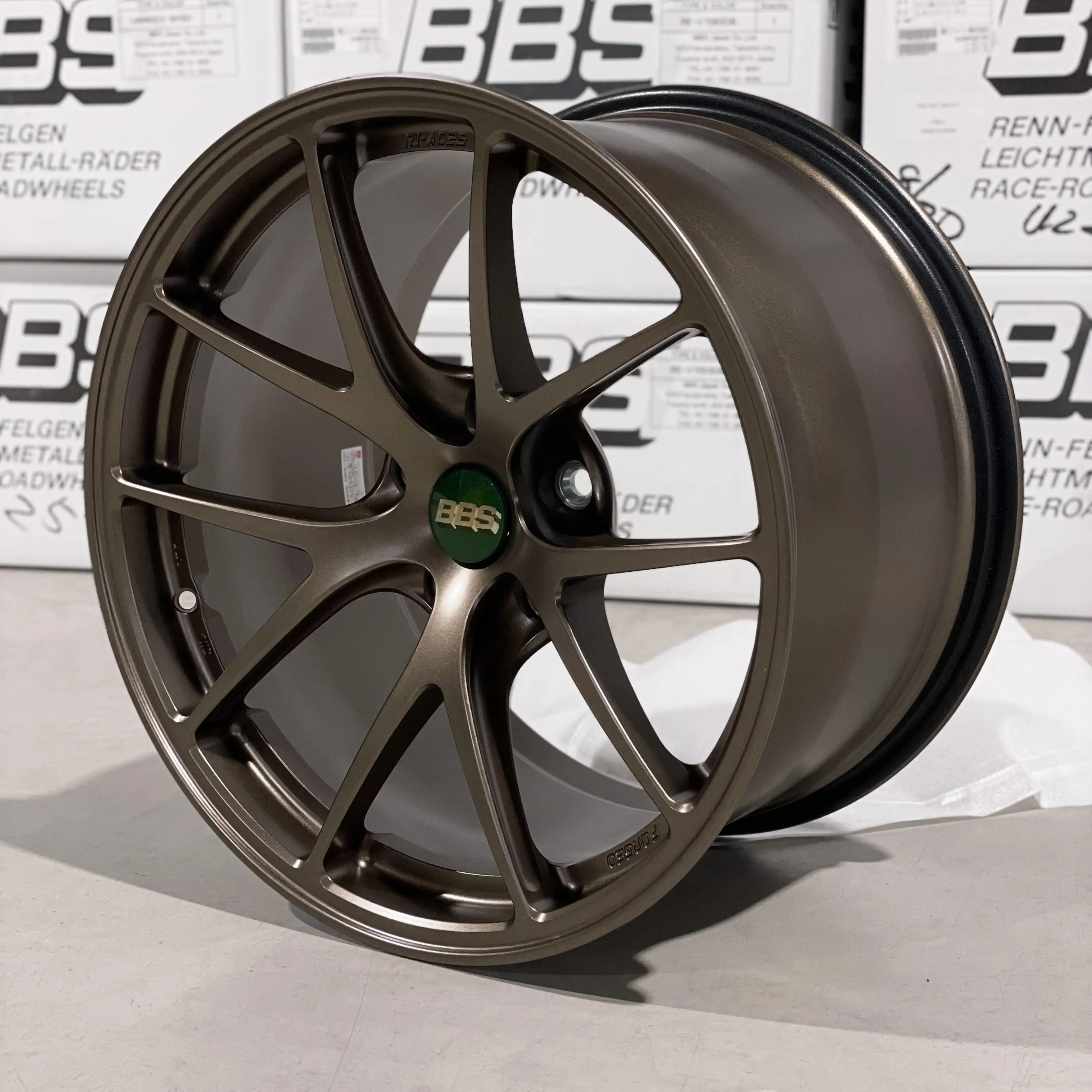 Three quarter studio perspective highlighting the rigid split five spoke profile of a Matte Bronze BBS RIA wheel