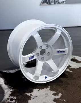 Close-up of 30th Anniversary engraved logo and red spoke decals on White RAYS Volk Racing TE37 SAGA S-Plus wheel