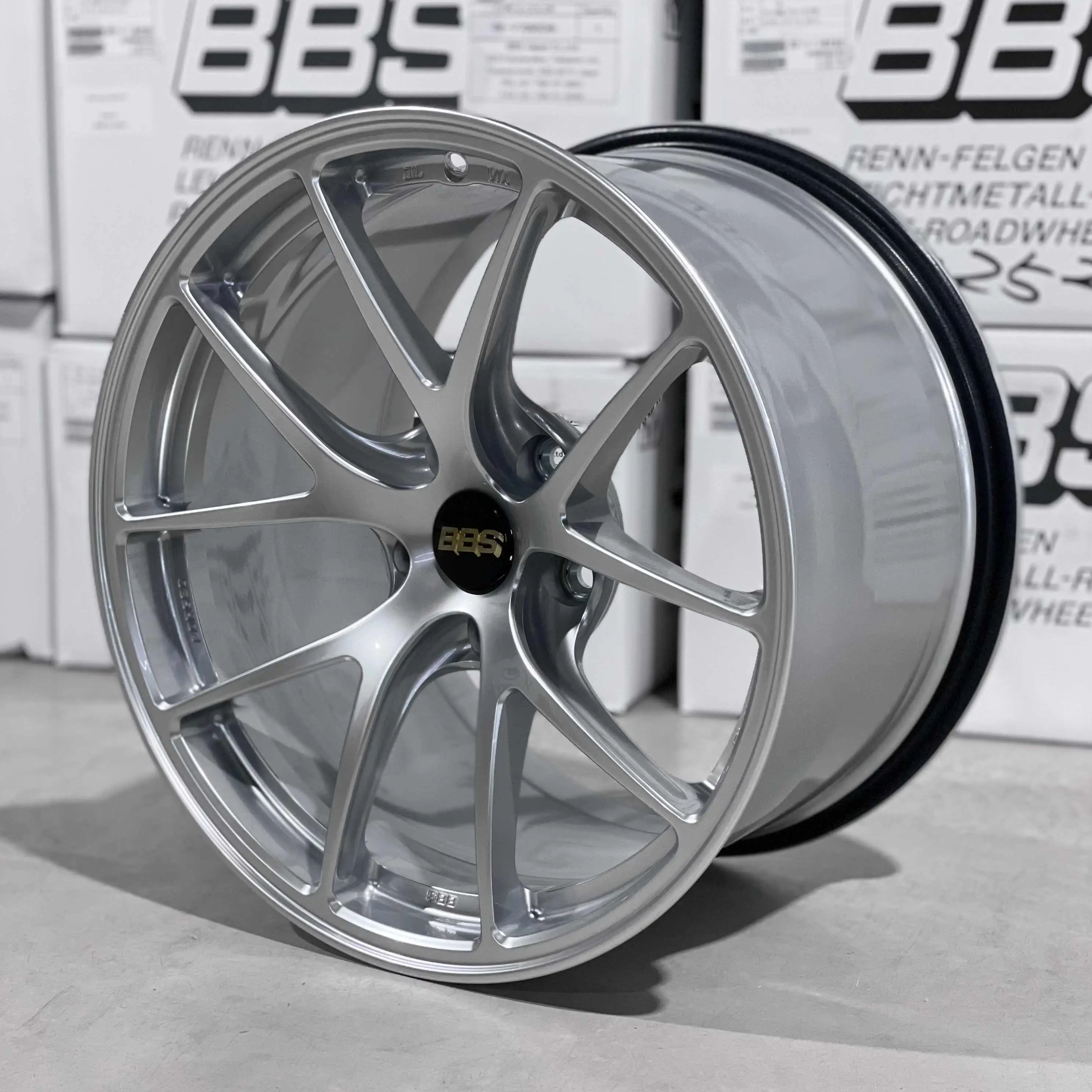 Three quarter studio perspective highlighting the split five spoke design of a Diamond Silver BBS RIA racing wheel