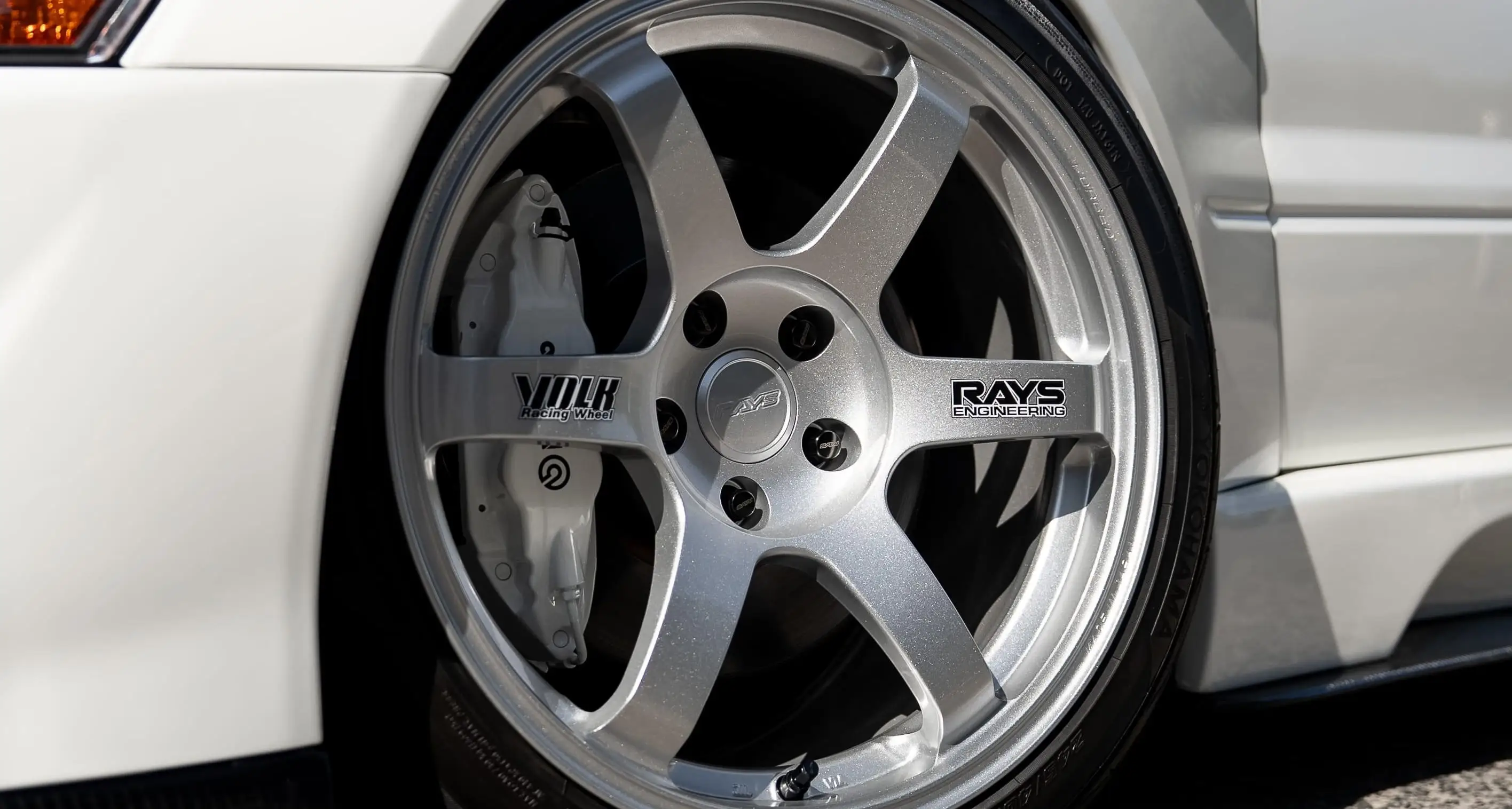 White Mitsubishi Lancer Evolution Evo 8 fitted with RAYS Volk Racing TE37 Saga SL forged wheels in Diamond Silver