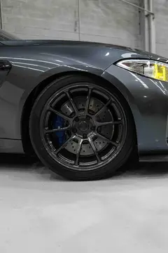 Front three-quarter view of BMW F87 M2 with 19-inch Diamond Dark Gunmetal RAYS ZE40 forged wheels