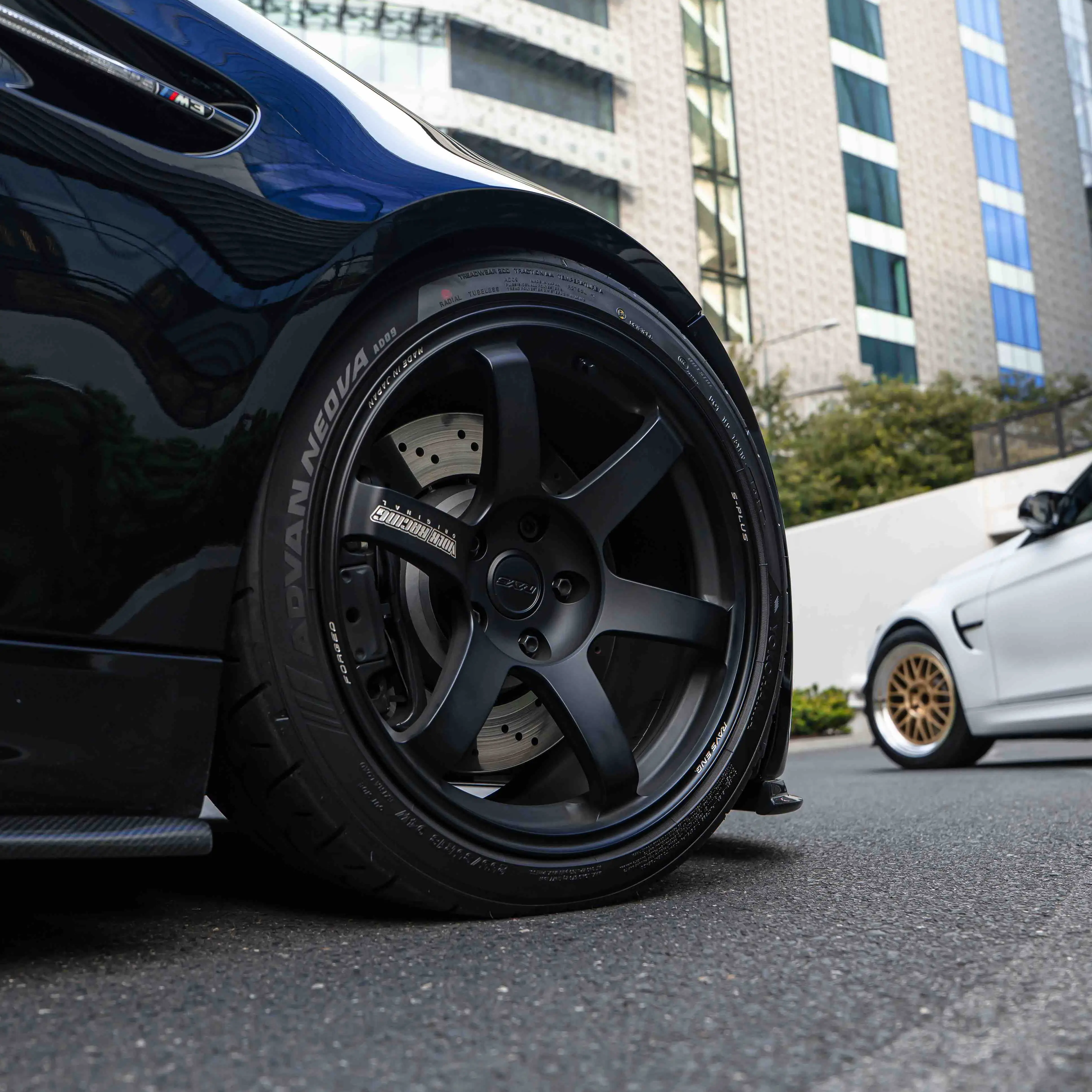 Low angle front stance view of a black BMW E92 M3 coupe running 18 inch Matte Black TE37 Saga S-Plus wheels