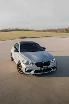 BMW F87 M2 coupe featuring a track inspired stance on Matte Bronze BBS RI-A forged wheels