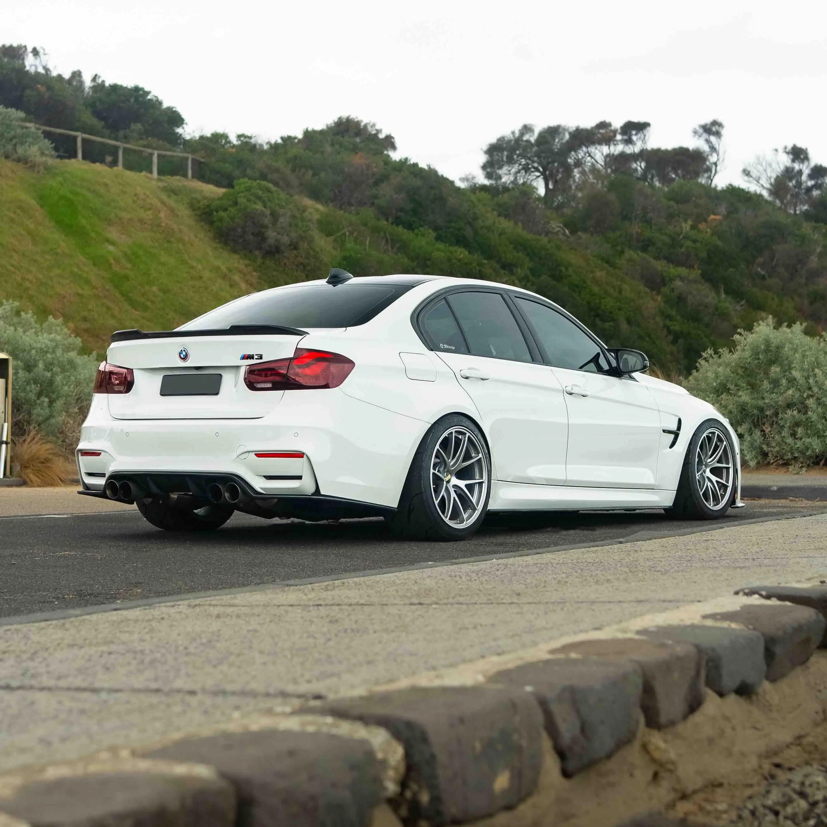 Detailed look at the aggressive wheel arch fitment and meaty tire setup on a Diamond Silver F80 M3 BBS RIA wheel