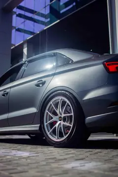 Audi RS3 sedan sitting on track spec BBS RI-A forged wheels in Diamond Silver