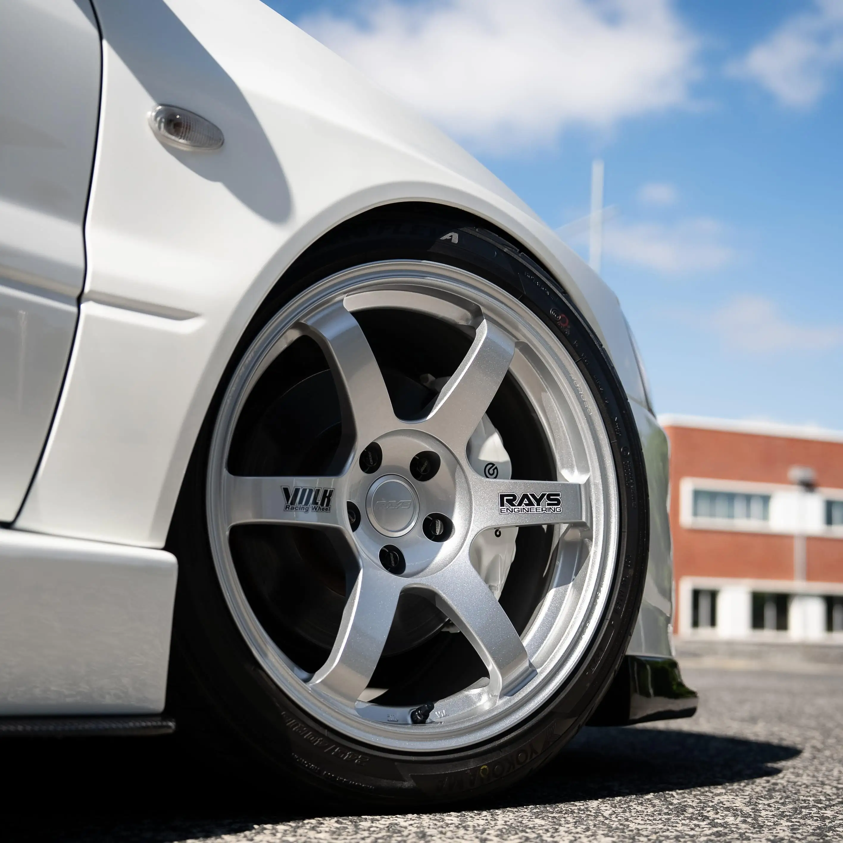 White Mitsubishi Lancer Evolution Evo 8 fitted with RAYS Volk Racing TE37 Saga SL forged wheels in Diamond Silver front close up profile