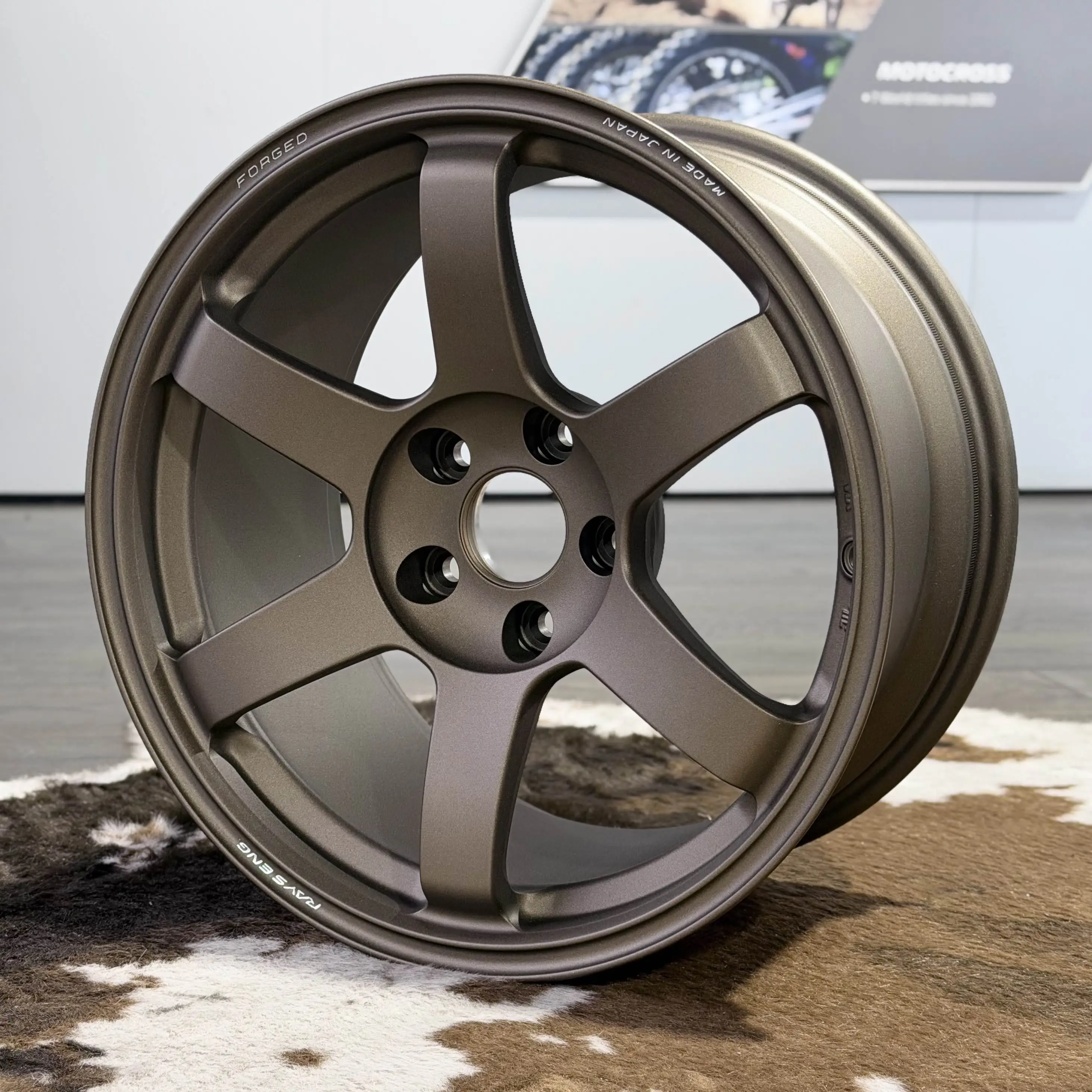 Side profile perspective highlighting the aggressive concave spoke face of a Matte Gun Bronze TE37 Saga SL