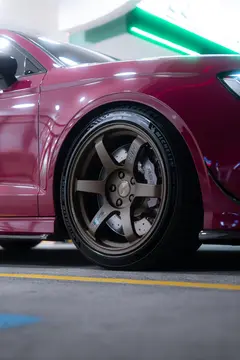 Audi 8V RS3 Sedan in Ruby Star Pink receiving Matte Gun Bronze RAYS TE37 SAGA SL wheel installation at KA Autosport Australia
