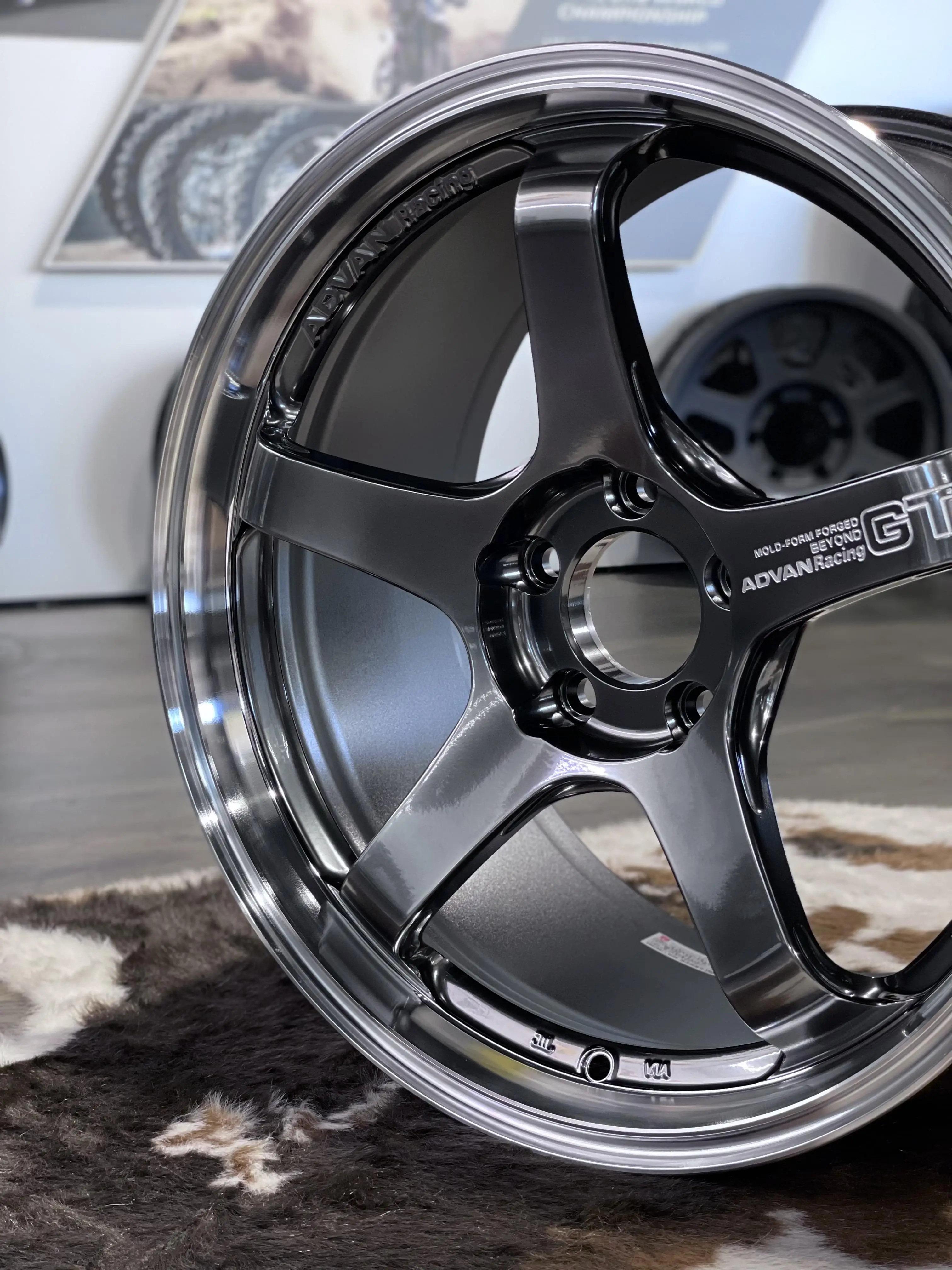 Three quarter studio view highlighting the thick concave five spoke profile of an MPB Advan GT Beyond wheel
