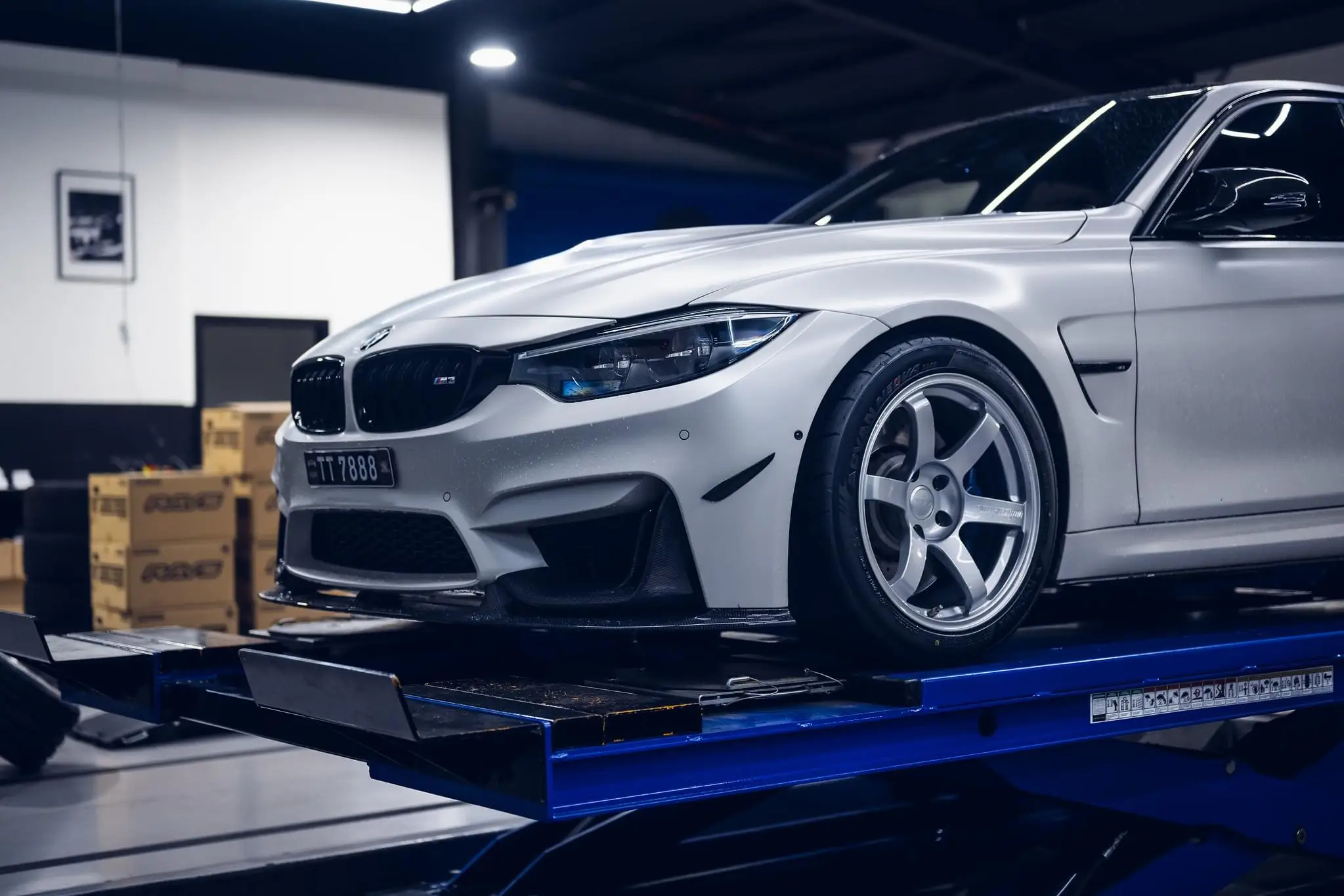 Front three quarter view of a lowered white BMW F80 M3 running Diamond Silver TE37 Saga S-Plus wheels