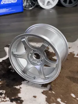 Detailed shot of 4x100 lug pattern hub bore and valve stem area on 15 inch RAYS 57DR