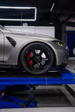Front three quarter view of a lowered BMW G80 M3 with gloss black TE37 Ultra M Spec wheels