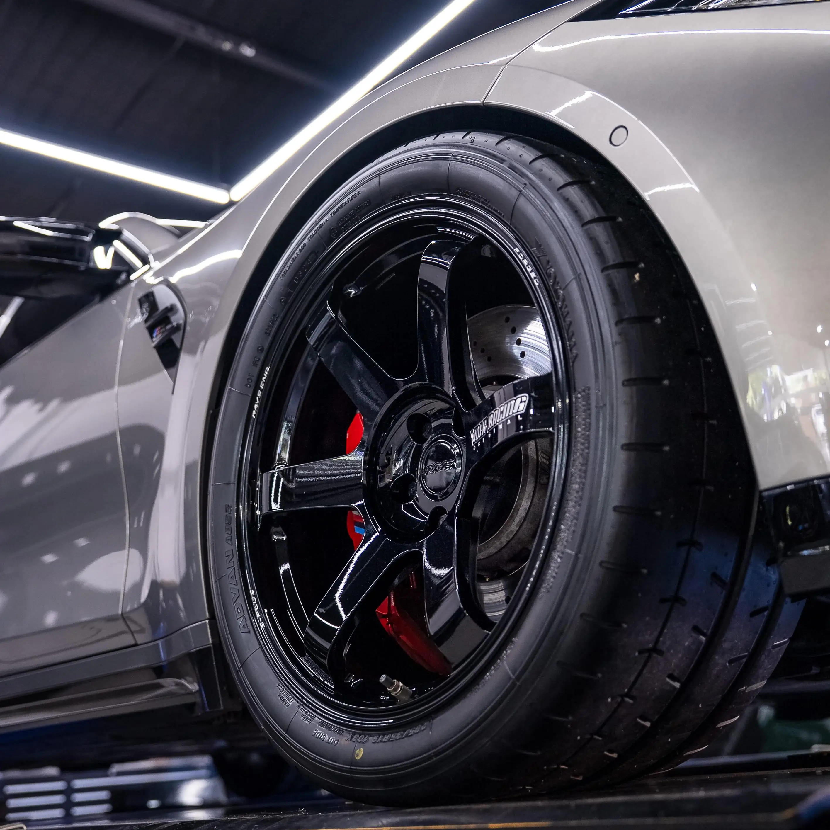 Gloss black TE37 wheel spokes cleanly clearing the massive factory M Sport brakes on a BMW G80 M3