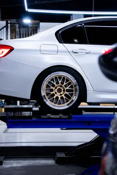 Close up showing the deep step-rim polished shiny silver outer lip of a Volk Racing 21A forged wheel
