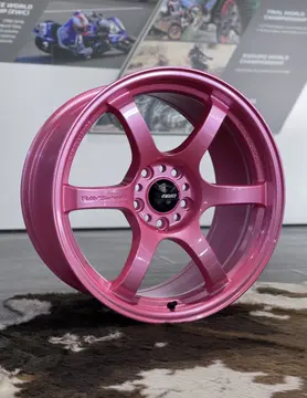 Side angle view illustrating the robust outer lip and aggressive concavity of an 18 inch track spec Sakura Pink wheel