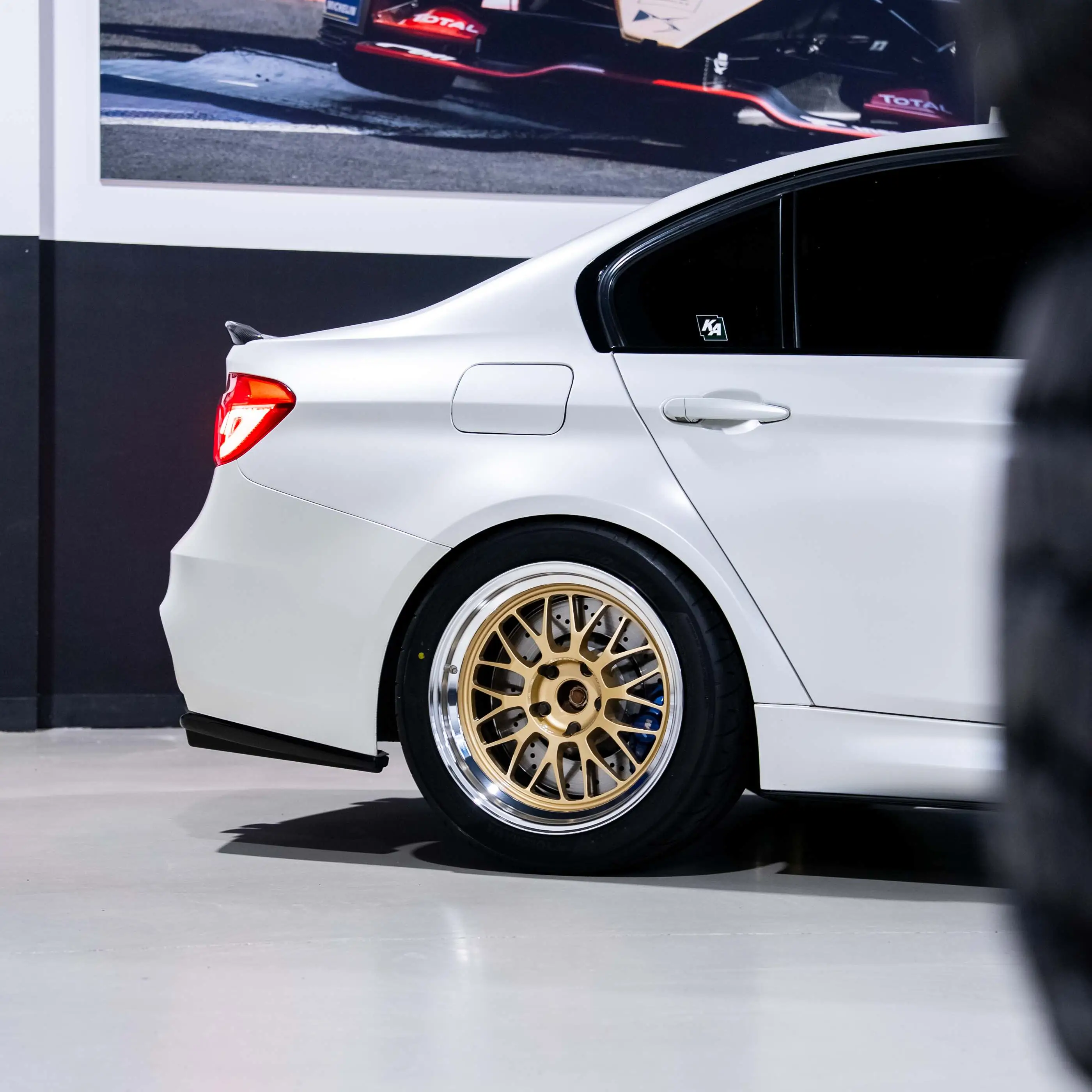 White BMW F80 M3 on hoist undergoing custom JDM wheel test fitment at KA Autosport Melbourne