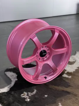 Close up of the center bore area showcasing the neon finish contrast on a genuine RAYS 57DR wheel