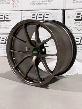 Three quarter studio perspective highlighting the rigid split five spoke profile of a Matte Bronze BBS RIA wheel